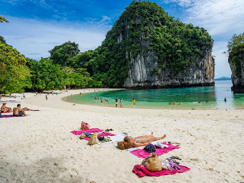 The white sand beach at Koh Hong with turquoise water and longtail boats
